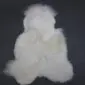 Large multi-layered white sheepskin rug with a thick, fluffy texture and irregular natural edges.