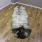 Long double sheepskin rug with natural cream, grey and dark brown wool markings.