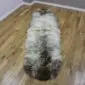 Long double sheepskin rug with thick cream wool and dark grey mottled markings.