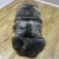 Long double sheepskin rug with thick, textured wool in mottled shades of grey, charcoal, and cream.