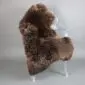 Large brown rare breed sheepskin rug with thick, textured wool laid flat.