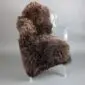 Large brown rare breed sheepskin rug with thick, curly wool laid flat.