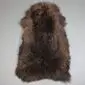 Large rare breed sheepskin rug with long, textured wool in mottled shades of dark and light brown.