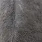 Close-up of grey cowhide rug showing natural hair texture and a central seam.