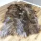 Large four-skin Icelandic sheepskin rug with long, shaggy wool in mottled rusty grey and brown tones.