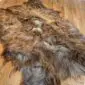 Large Icelandic sheepskin rug with long, shaggy wool in mottled rusty brown and grey tones. detail view