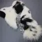 Large multi-layered sheepskin rug featuring irregular patches of white, black, and grey patterned fur.