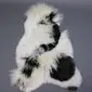 Large multi-layered sheepskin rug with long white and black wool patches.