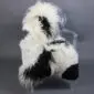 Large multi-layered sheepskin rug with long white and black wool laid flat.