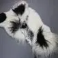 Large multi-layered sheepskin rug featuring long-pile white wool with irregular black patches.