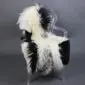 Large multi-layered sheepskin rug with long cream and black wool laid flat.
