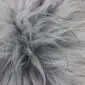 Close-up of a natural grey Icelandic sheepskin rug showing long, textured wool fibres.