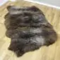 A large, three-skin rare breed sheepskin rug with thick, textured wool in mottled shades of dark brown and grey.