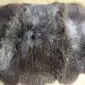 Close-up of a rare breed sheepskin rug with long, textured wool in mottled shades of grey, brown and cream.
