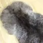 Long, thick grey and brown rare breed double sheepskin rug with natural curved edges.