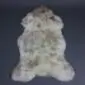 Natural rare breed sheepskin rug with cream wool and grey and brown mottled markings.