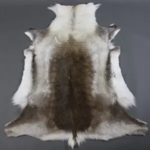 Large reindeer hide rug with a dark brown centre and cream and grey outer edges.